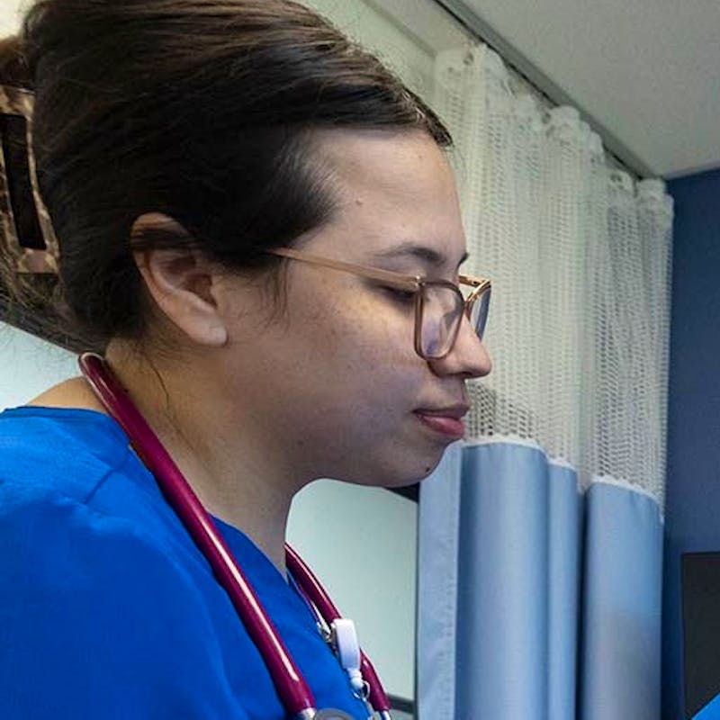 Healthcare students practice on a dummy