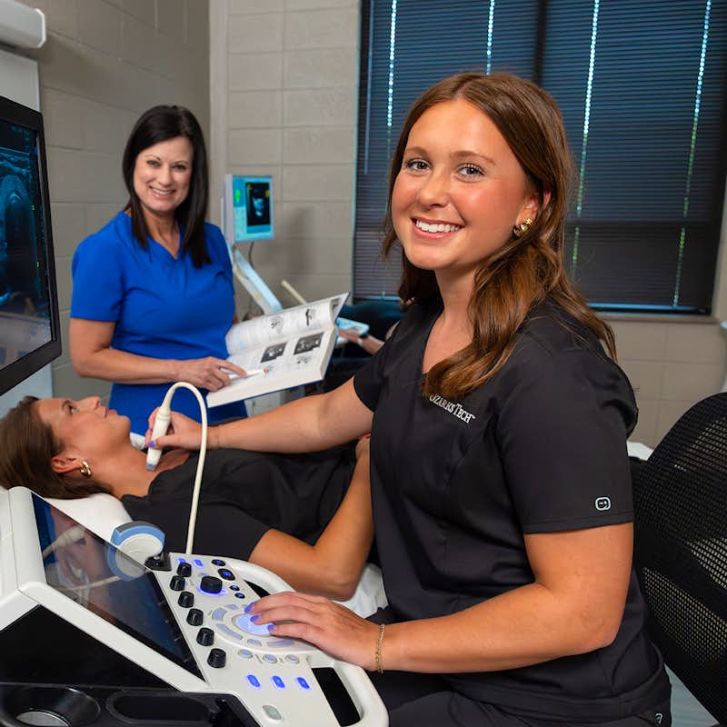 Sonography student practices in a clinical setting.